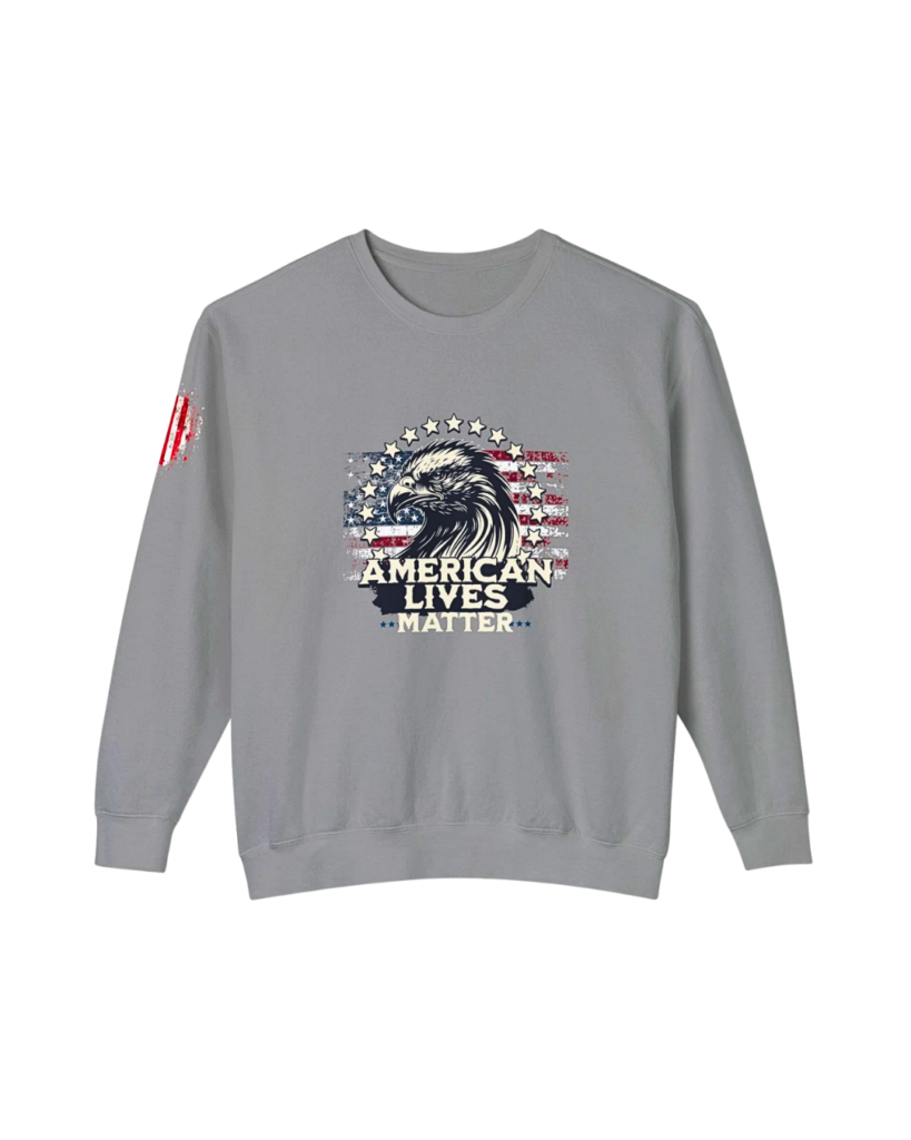 A high-contrast studio shot of the "American Lives Matter" crewneck sweatshirt, showcasing the premium ring-spun cotton texture, relaxed fit, and bold patriotic typography against a gritty, dark background.